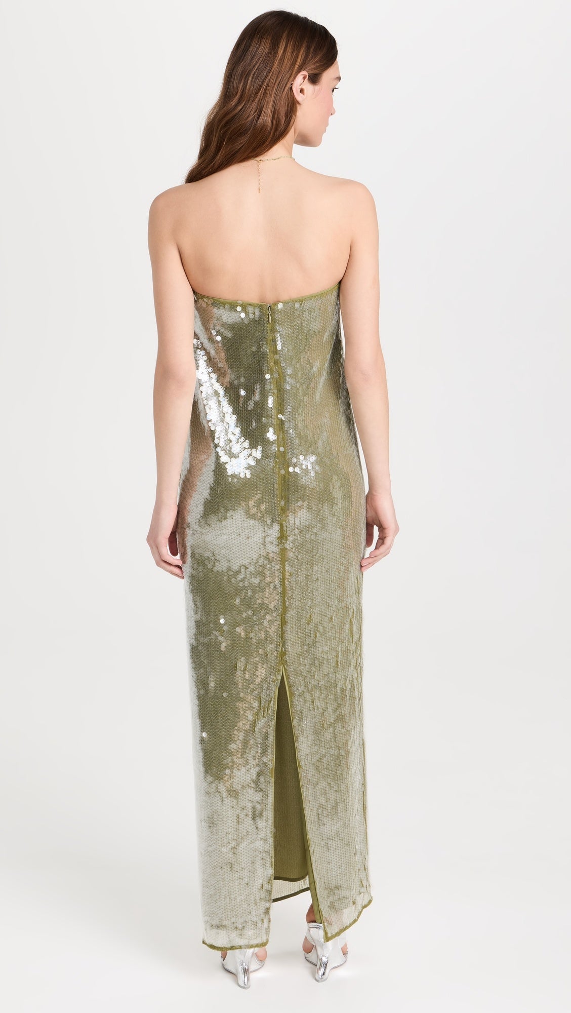 The Casey Dress by Staud combines contemporary elegance with practical sophistication. Crafted from mid-weight mesh, this strapless silhouette features allover iridescent paillette embellishments that catch light beautifully. The non-slip rubber binding ensures a secure fit, while the back slit adds movement and visual interest. Secured with a hidden zip and hook-and-eye closure for a seamless finish.