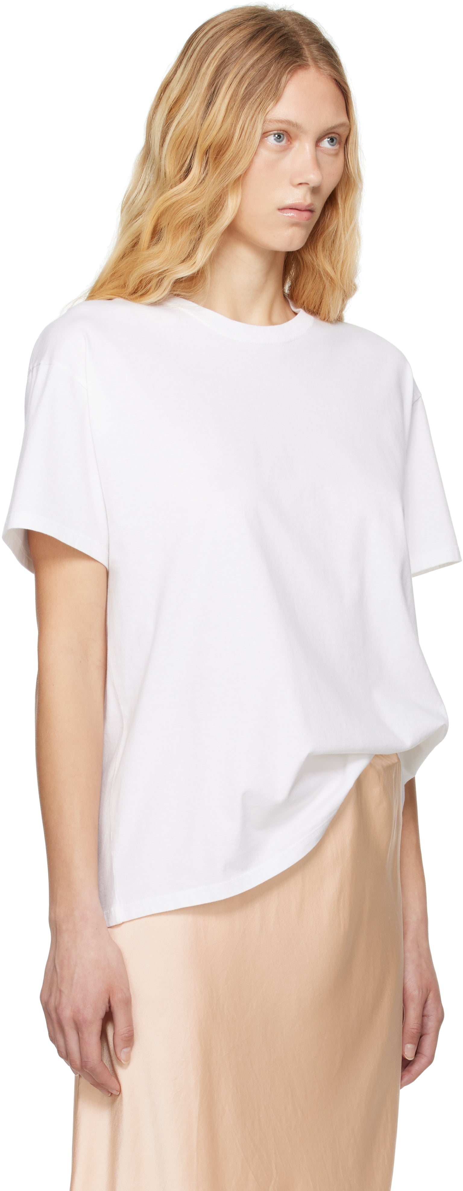 The White Nadina Oversized Short-Sleeve Top by The Row is expertly crafted from soft white cotton, balancing comfort with sophisticated design. Its classic crew neckline and short sleeves complement the clean, straight hem, while the oversized fit provides relaxed ease enhanced by subtle ribbed detailing for added texture and structure. This versatile tee offers a refined, effortless aesthetic, perfect for layering or standalone wear.