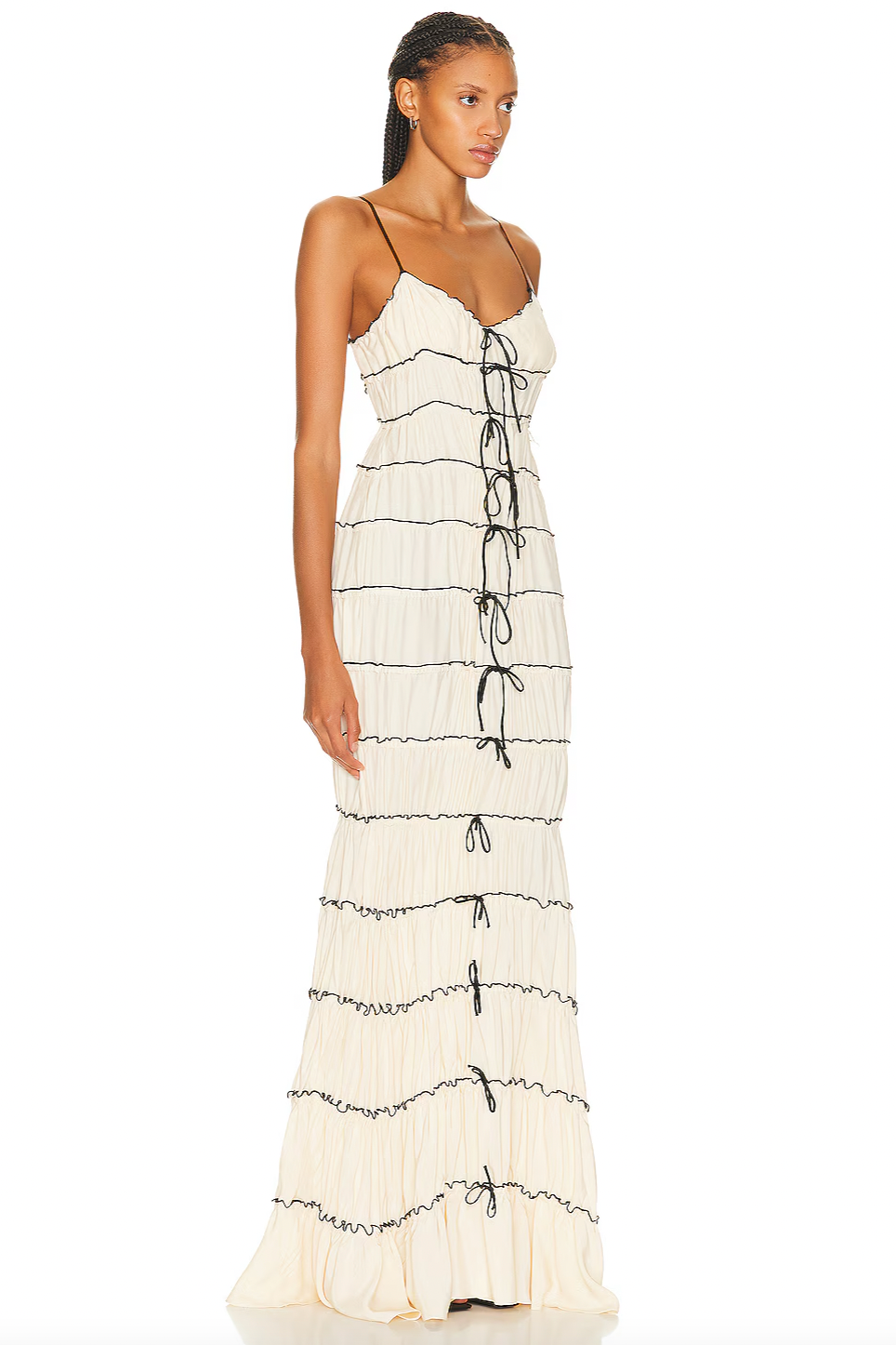The Ruffle Tunnel Gown features a discreet side zipper closure for a seamless look and tie embellishments that enhance the front and back seams with delicate detail. Crafted from tiered ruched fabric with a luxurious satin finish, this gown offers both texture and a subtle sheen, combining elegant structure with fluid movement for a sophisticated silhouette.
