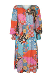 The Cha Cha Boho Midi Dress by Spell combines breathable, lightweight fabric with a refined design for ultimate comfort in warm weather. Its pull-on style and partial button front simplify dressing, while the tasseled tie neckline and cinched ruffled cuffs create a subtle, elegant bohemian aesthetic. This dress is an expert choice for those prioritizing both comfort and sophisticated style in their wardrobe.