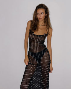 Indulge your inner siren with the Gisele Dress from Rat and Boa. Inspired by 90s fashion, this slip dress is made from sheer polka dot silk, hugging your curves in all the right places. The cowl neck and open back add irresistible charm. Channel your inner goddess in this must-have piece.