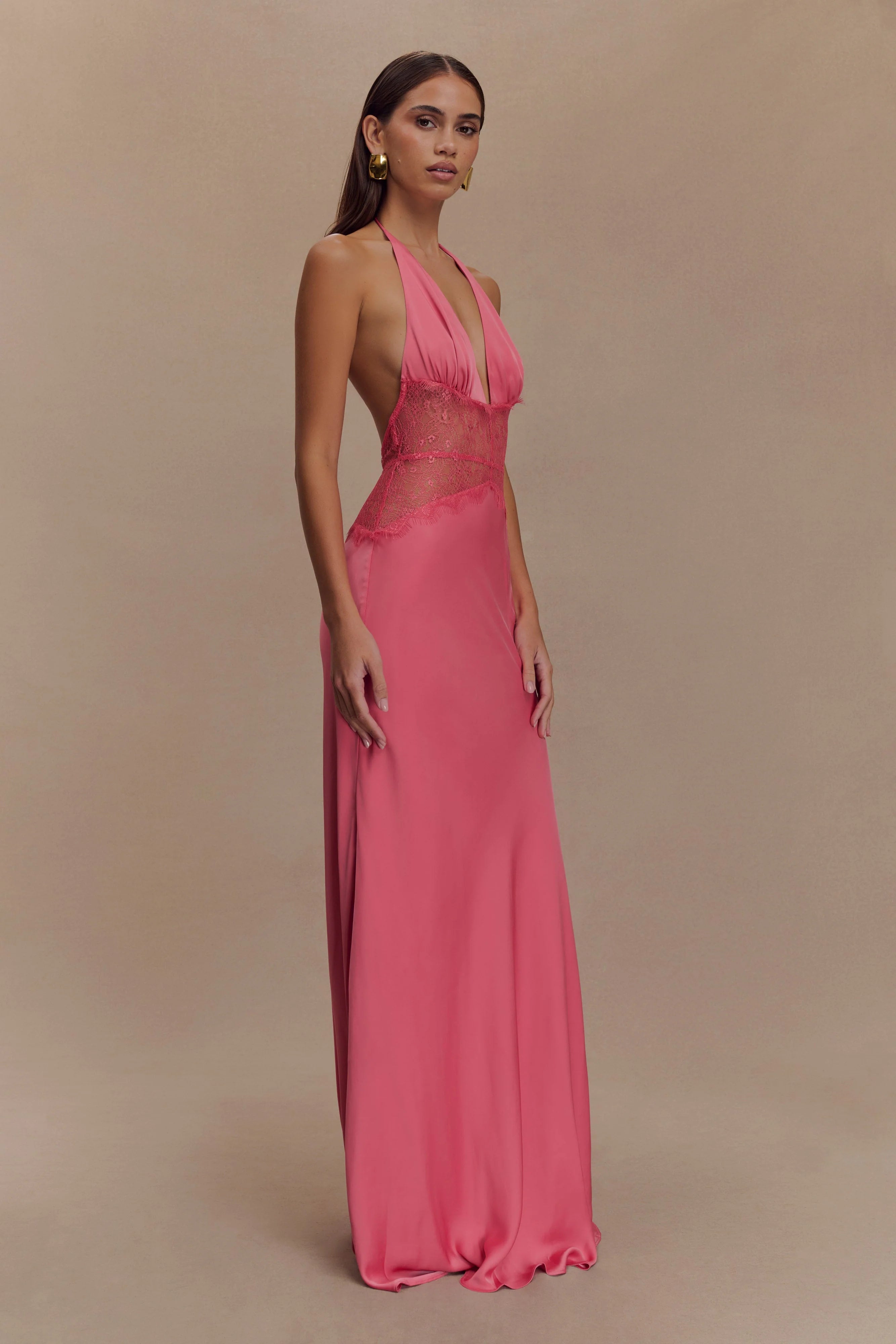 The Dinah Satin Dress offers a refined blend of elegance and allure with its halter tie V-neckline and softly gathered bust. Crafted with a sheer lace body that gracefully follows your silhouette, it features a dramatic low back and a maxi length for timeless sophistication. Partially lined and equipped with an invisible zip, this dress ensures a flawless fit and subtle coverage, perfect for making a confident statement at any special occasion.