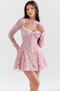 Get ready to charm in the Alice Mini Dress. Made from beautiful floral lace in a dreamy pink shade, this dress features a flattering waistline and supportive underwired cups. The flowing silhouette will show off your sun-kissed legs. And for versatility, it comes with a detachable tie front shrug. Perfect for any occasion.