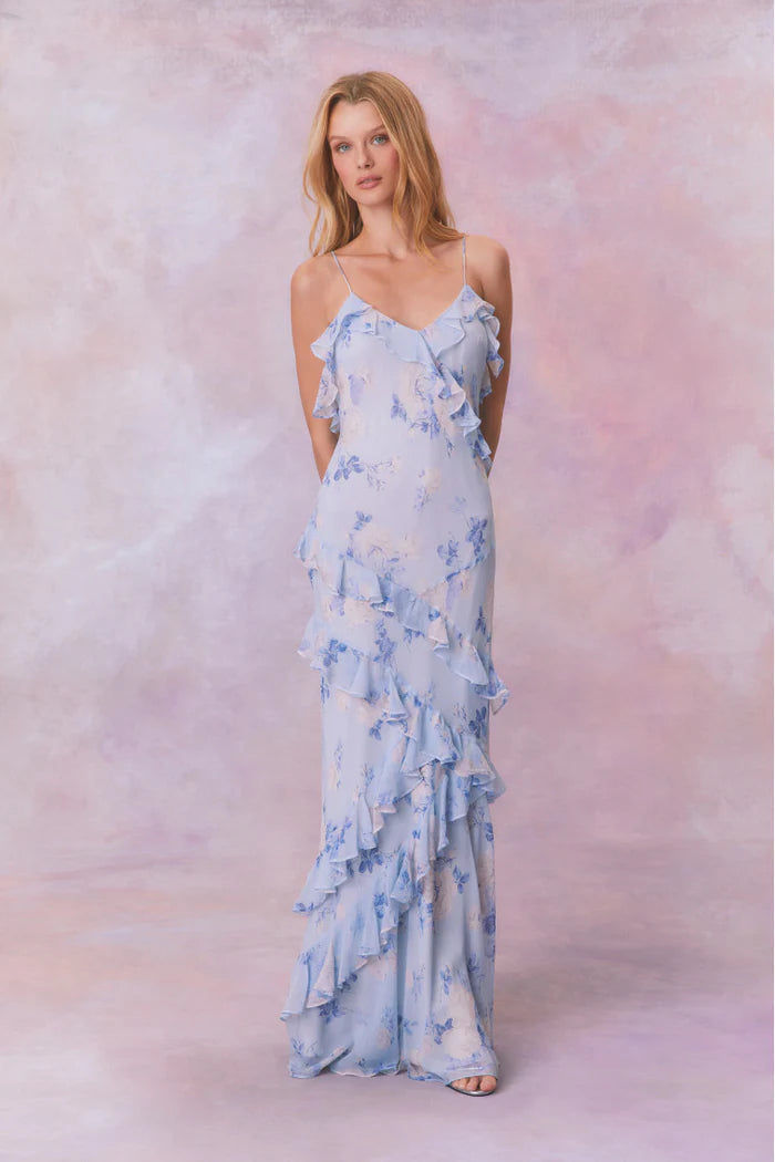 Designed with elegance and movement in mind, the Rialto Maxi Dress in Whisper Blue captivates with its chiffon fabric and cascading asymmetrical ruffles that flow from neckline to hem. Its slightly fitted silhouette enhances your figure with subtle allure, while a discreet side seam zipper ensures a seamless fit. Perfect for dancing or any refined occasion, this dress combines comfort with sophisticated style effortlessly.