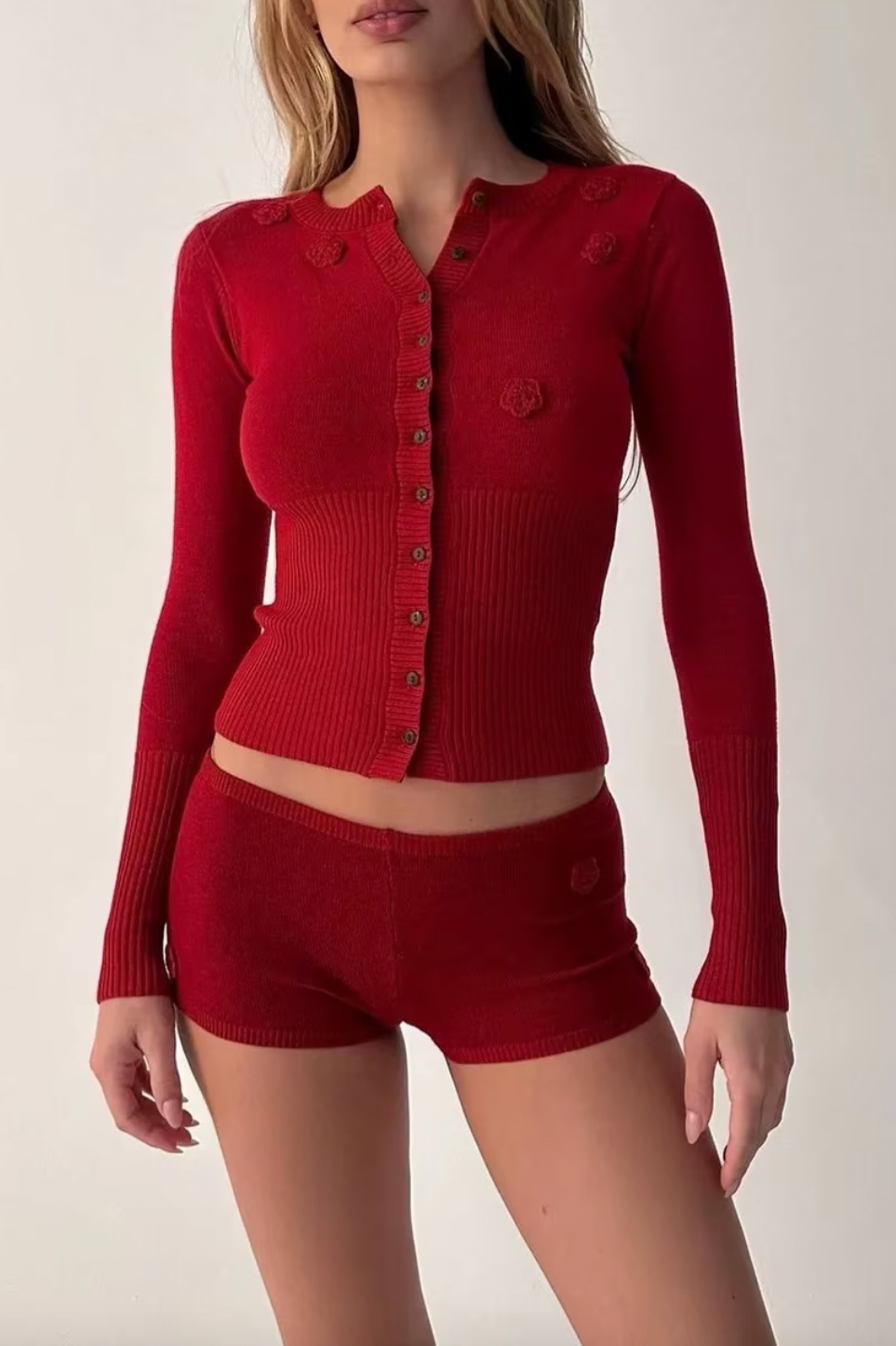 Indulge in luxurious warmth this season with the Lenon Cloud Knit Button Up Cardigan by Frankies Bikinis. The signature cloud knit fabric creates a soft and cozy feel, while the functional buttons and exaggerated cuffs add an elegant touch. Complete with ribbing on the waist and cuffs, the Lenon cardigan is the perfect statement piece for your winter wardrobe.