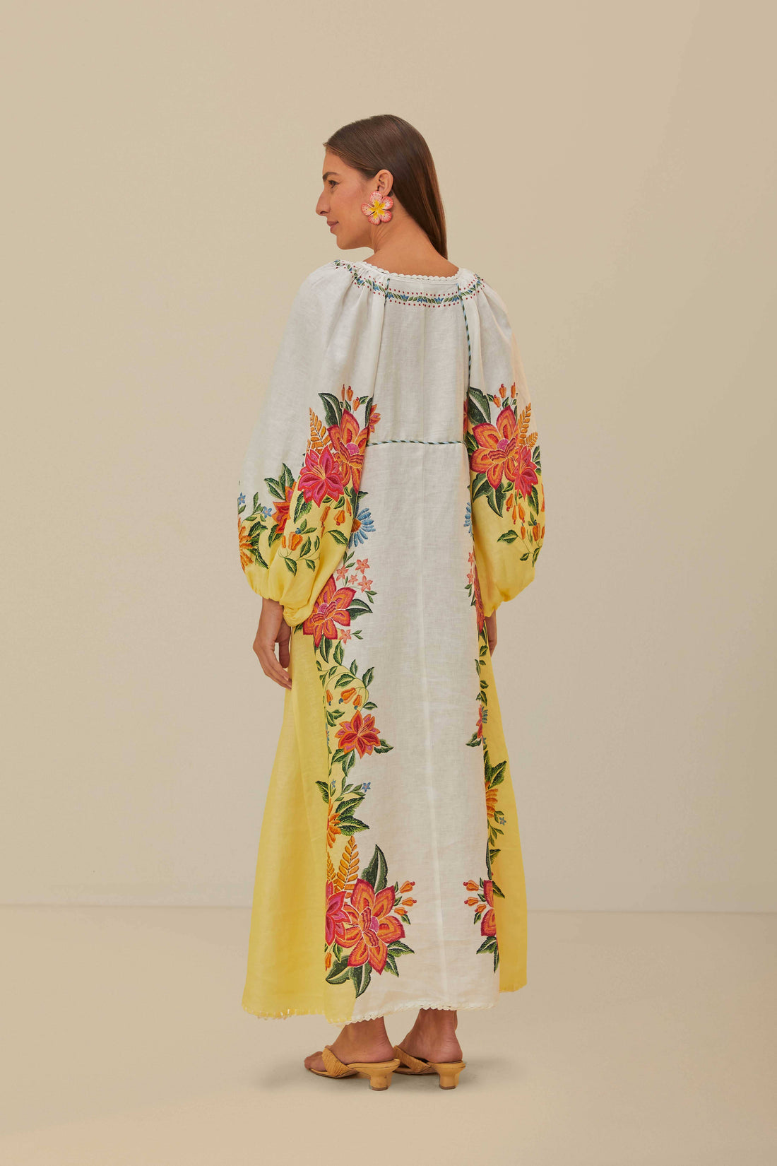 Experience the beauty of the Garden Maxi Dress from FARM Rio. With delicate eyelet details and playful tassel ties, this enchanting piece accentuates your figure with a v-neckline. The rich, folk-inspired embroidery cascades down the billowing, off-white fabric, adding elegance to the flowing maxi-length silhouette. A must-have for sun-drenched days and warm, breezy evenings.