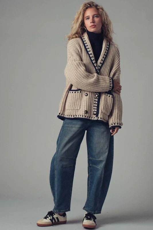 Embrace effortless layering with this boho-inspired chunky knit cardigan, designed for versatile styling. The relaxed silhouette and deep front pockets make it equally at home over a dress, denim vest, or as part of a coordinated set. Crafted from soft, heavyweight yarn, this piece delivers substantial warmth without sacrificing comfort, making it an essential addition to any transitional wardrobe. Perfect for creating dimension in your outfits while maintaining that coveted relaxed aesthetic.