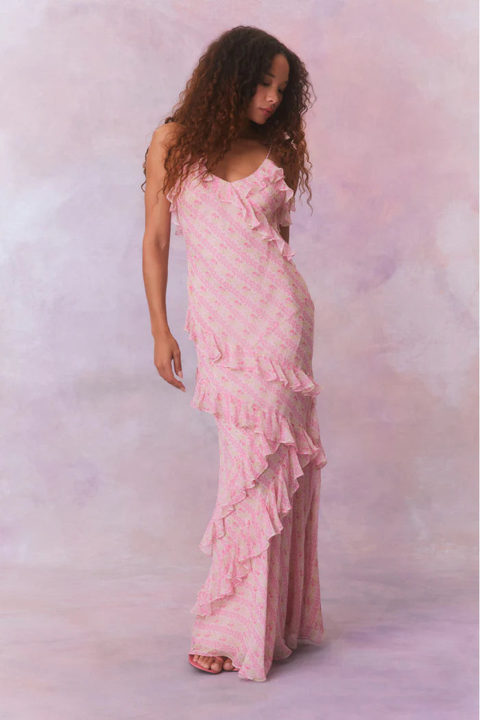 Designed with elegance and movement in mind, the Rialto Maxi Dress in Strawberry Macaroon captivates with its chiffon fabric and cascading asymmetrical ruffles that flow from neckline to hem. Its slightly fitted silhouette enhances your figure with subtle allure, while a discreet side seam zipper ensures a seamless fit. Perfect for dancing or any refined occasion, this dress combines comfort with sophisticated style effortlessly.