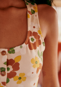 The Fabiola Dress is a sleeveless midi dress crafted from organic cotton, offering breathable comfort and sustainability. Its square neckline provides a modern, flattering silhouette, while the front button placket adds a refined detail for easy wear and subtle style. Ideal for those seeking a versatile, eco-conscious wardrobe staple.
