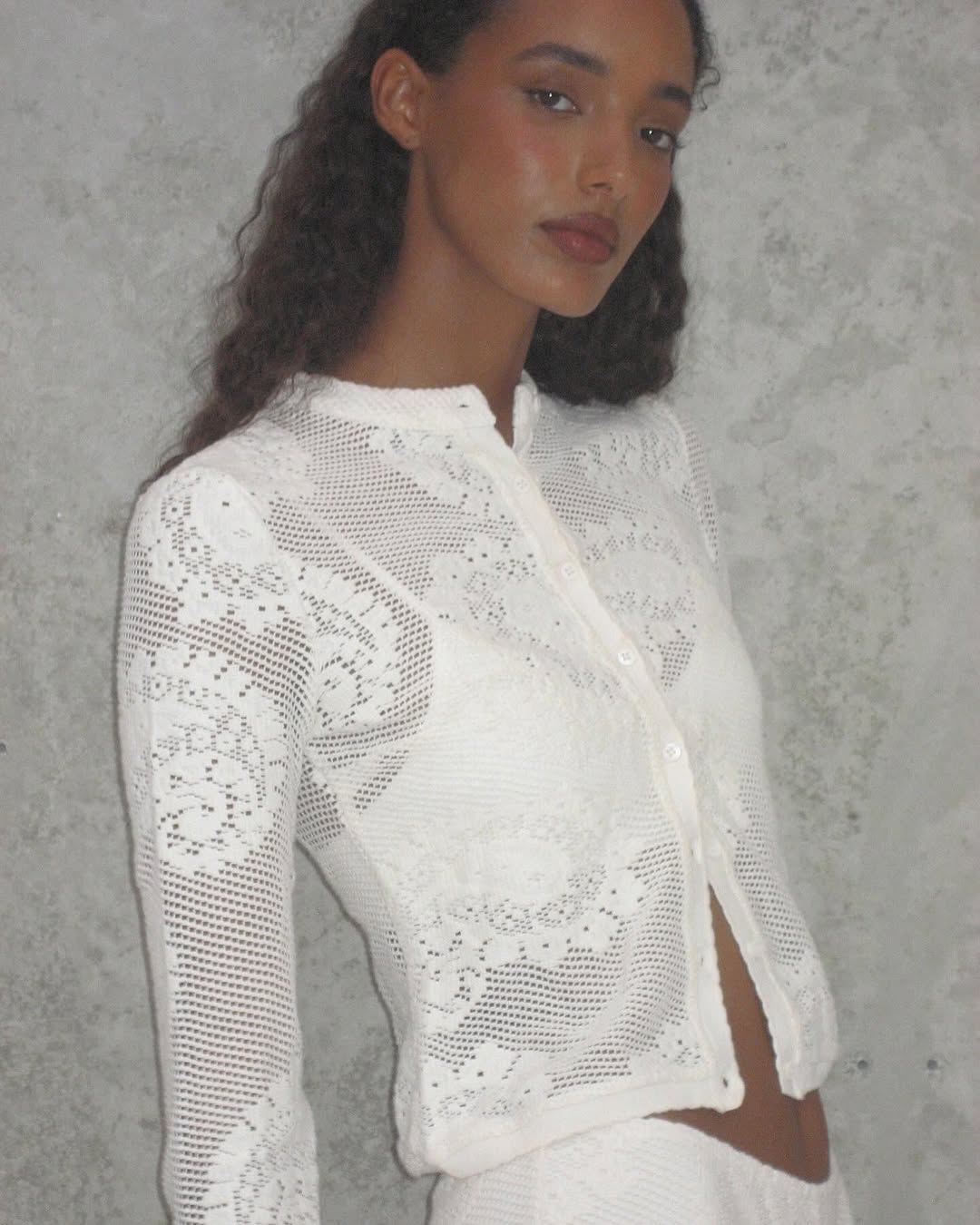 Elevate your wardrobe with the Dom Set by With Jean, expertly combining refined craftsmanship and elegant design. The Dom Top is a long-sleeve cardigan featuring a button-up front, a polished neckline collar, and delicate scalloped trim, enhanced by custom hand-drawn crochet lace for a sophisticated finish. Complementing the top, the Dom Shorts offer comfort with a fully lined interior and an elasticated waistband, adorned entirely with the same intricate crochet lace. 