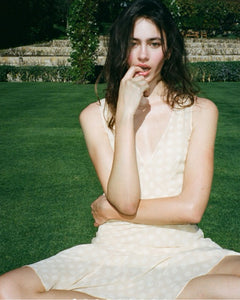 The Cleo Dress in Honey Spot by Realisation embodies effortless femininity with its light, floaty fabric and delicate sheer design. Featuring a flattering plunging V-neckline, sculpting panelled waist, and a fluted skirt that drapes gracefully, this dress is perfect for warm summer days and sultry evenings. The slightly shorter hemline adds a playful touch, while the removable underslip allows you to customize your look—opt for bold sheerness or a more refined silhouette. 