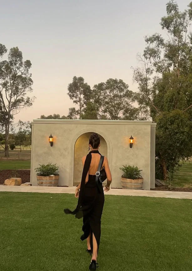 The Amber Maxi Dress by Helsa Studio combines refined elegance with bold design. Featuring a sculpted silhouette and delicate draping, it flatters the figure while the halter neckline and sheer scarf add refined sophistication. The flared hem enhances graceful movement, complemented by a sheer bodice that introduces a confident, modern edge. Perfect for special occasions, this dress delivers a distinctive and memorable style with expert craftsmanship.