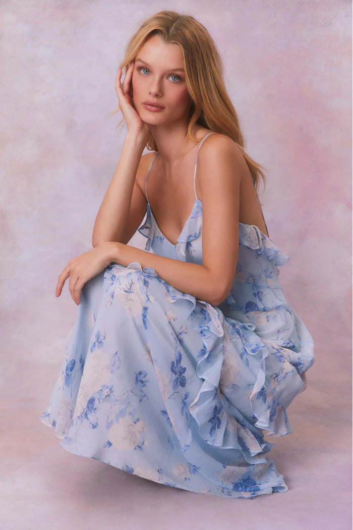Designed with elegance and movement in mind, the Rialto Maxi Dress in Whisper Blue captivates with its chiffon fabric and cascading asymmetrical ruffles that flow from neckline to hem. Its slightly fitted silhouette enhances your figure with subtle allure, while a discreet side seam zipper ensures a seamless fit. Perfect for dancing or any refined occasion, this dress combines comfort with sophisticated style effortlessly.