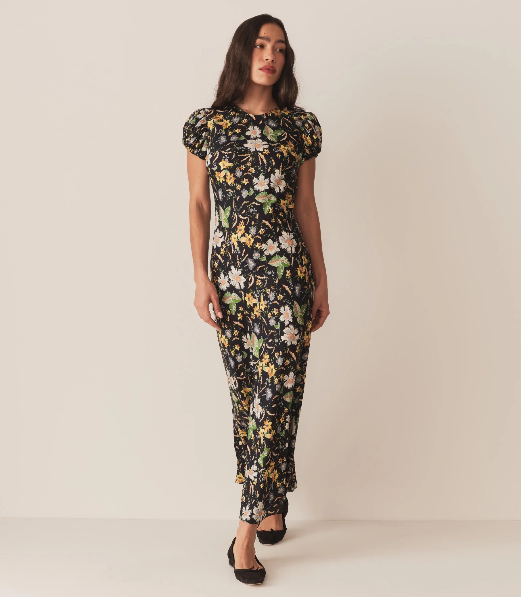 Crafted from a drapey silk-viscose twill, the Merla Dress by Doen in Sweet Anemone boasts an elegant bias cut that flatters the silhouette. Inspired by Art Deco motifs, this dress features a refined high neck and delicate short puffed sleeves, blending timeless style with modern sophistication. Perfect for occasions that call for understated glamour.