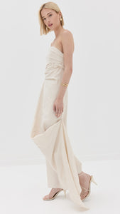 Introducing the Caravaggio Dress by STAUD, a masterpiece in fashion. The boned bodice provides structure and support, while the gathered design adds a touch of elegance. With an asymmetric hem and strapless design, this dress will make you feel confident and beautiful. The hook-and-eye and hidden zip at the back ensure a perfect fit. Embrace your inner fashionista and make a statement with the Caravaggio Dress!