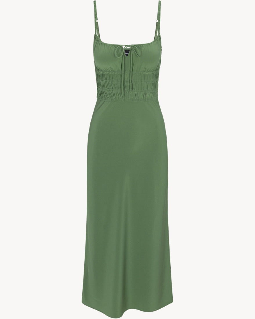 The Camille in Poison by Realisation Par blends chic minimalism with versatile design. Crafted from solid-colored silk, it features a milk-maid style bust with a keyhole detail that can be tied for added lift or left untied for a relaxed, elegant look. The form-fitting elasticated torso and back, adjustable straps, and bias-cut skirt ensure a flattering fit on various body shapes. Pair with kitten heels to complete a sophisticated yet effortlessly alluring ensemble.