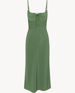 The Camille in Poison by Realisation Par blends chic minimalism with versatile design. Crafted from solid-colored silk, it features a milk-maid style bust with a keyhole detail that can be tied for added lift or left untied for a relaxed, elegant look. The form-fitting elasticated torso and back, adjustable straps, and bias-cut skirt ensure a flattering fit on various body shapes. Pair with kitten heels to complete a sophisticated yet effortlessly alluring ensemble.