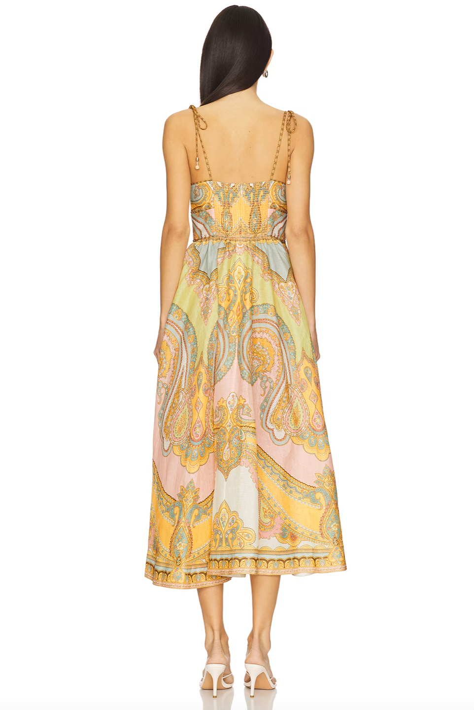 The Maxine Picnic Midi Dress by Zimmermann features a boned bodice with a smocked back for a tailored yet flexible fit. Crafted from lightweight linen, it ensures breathable comfort during warm days. The unlined design pairs with self-tie shoulder straps and a hidden back zipper closure for a sleek silhouette. Functional side seam pockets add practicality without compromising style, making this dress an expert choice for effortless, elegant summer wear.