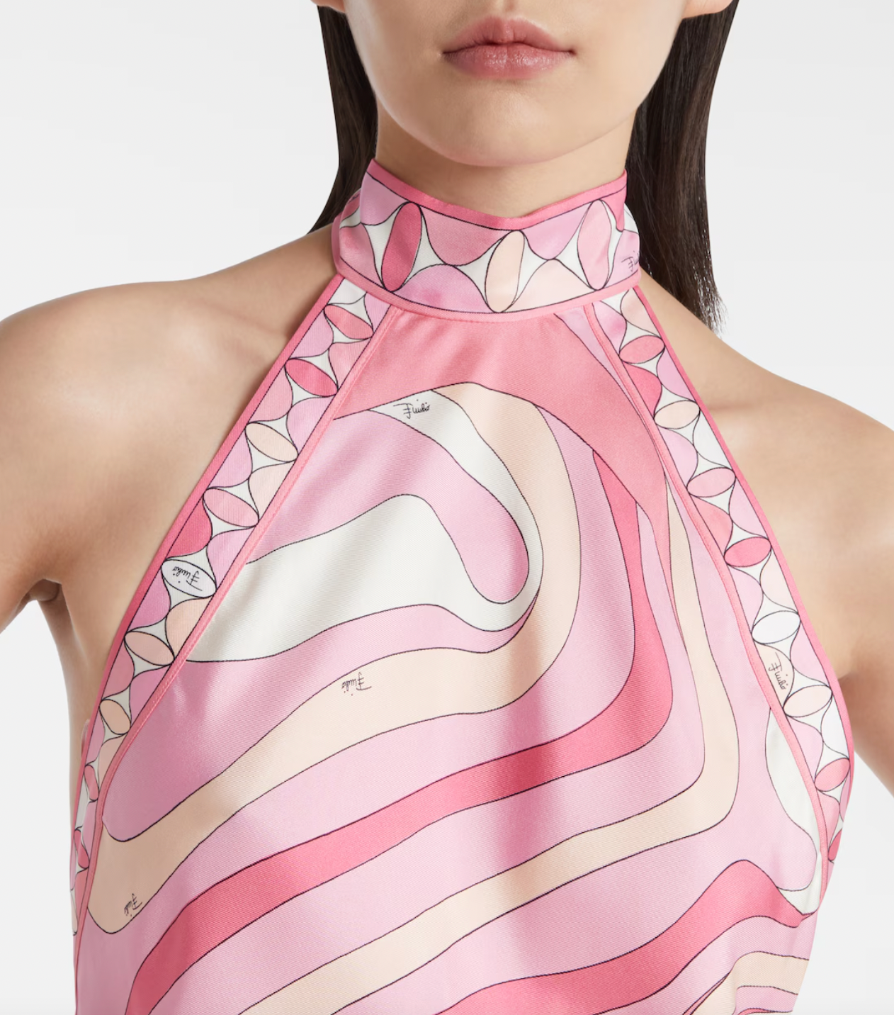 Embodying Pucci’s signature psychedelic swirling Marmo print, this silk maxi dress showcases expert craftsmanship and distinctive design. The asymmetric hem adds modern movement, while the high neckline and low back ensure a sophisticated yet alluring silhouette. Perfect for those seeking timeless elegance combined with bold, recognizable flair.