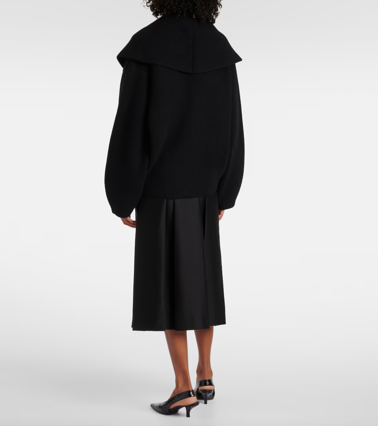 This Toteme wool-blend cardigan offers refined warmth and timeless style. Crafted from a premium wool blend, it provides softness and insulation perfect for layering in cooler weather. Its clean lines and subtle detailing ensure a versatile piece suitable for both casual and more polished looks, making it a valuable addition to any discerning wardrobe.