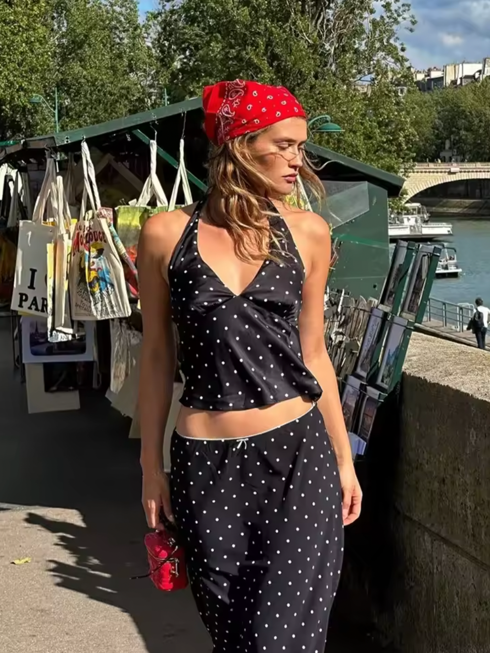 Embrace timeless elegance with the Iris Set, a vintage-inspired two-piece ensemble perfect for summer. Featuring a V-neck halter top paired with a straight skirt, this polka dot outfit blends retro charm with modern sophistication. Ideal for beach outings or stylish daywear, it offers both comfort and grace, ensuring you make a confident statement wherever you go.