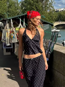 Embrace timeless elegance with the Iris Set, a vintage-inspired two-piece ensemble perfect for summer. Featuring a V-neck halter top paired with a straight skirt, this polka dot outfit blends retro charm with modern sophistication. Ideal for beach outings or stylish daywear, it offers both comfort and grace, ensuring you make a confident statement wherever you go.