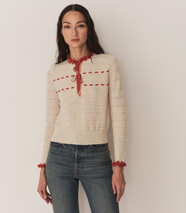 Inspired by 1940s knitwear, the Cordelie Top in Moonstone features a luxurious blend of 80% baby alpaca and 20% silk for exceptional softness and warmth. Lightweight yet insulating, this layerable piece offers delicate sophistication with silk grosgrain ribbons that tie elegantly at the neck. Crafted in Peru with sheer opaque fabric, it combines refined heritage style with modern comfort for versatile wear.