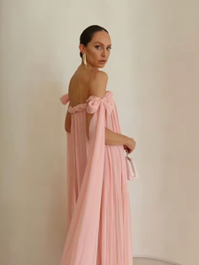Elevate your elegance with this draped floor-length dress featuring an intricate braided neckline and a corset bodice lining for subtle structure. The tie arm straps flow gracefully into a train, complementing the relaxed silhouette. An invisible back zip closure ensures a seamless finish, while the sheer tulle lining adds delicate dimension to this sophisticated design.