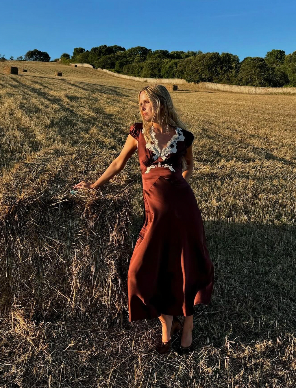 Elevate your wardrobe with the Coraline Dress by Dôen, crafted from luxurious silk satin for a graceful drape. This sophisticated midi dress showcases delicate scalloped lace along the neckline and intricate lace trim, enhancing its bohemian charm. The tie-detailed waist accentuates your silhouette, offering a refined yet effortless elegance perfect for any occasion.