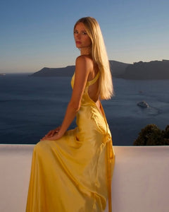 Elevate your presence and ignite your senses with the Monique Dress by Arcina Ori. This floor-length, bias-cut gown boasts a luxurious rich yellow hue that accentuates your curves. With an asymmetrical one-shoulder design, striking open back, and crossover detailing, Monique is crafted to embrace the feminine form.