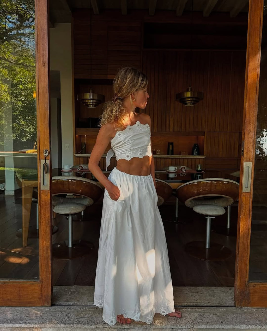 The Antoinette Set by Posse showcases timeless elegance through its meticulously crafted cotton construction and refined A-line silhouette. This high-waisted design features delicate pleating and vintage-inspired embroidery that elevates its aesthetic appeal. The hidden elasticated waistband ensures comfort while maintaining a polished silhouette, while side pockets add practical functionality. The full, gathered skirt drapes beautifully and is fully lined for a refined finish. 