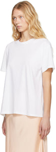 The White Nadina Oversized Short-Sleeve Top by The Row is expertly crafted from soft white cotton, balancing comfort with sophisticated design. Its classic crew neckline and short sleeves complement the clean, straight hem, while the oversized fit provides relaxed ease enhanced by subtle ribbed detailing for added texture and structure. This versatile tee offers a refined, effortless aesthetic, perfect for layering or standalone wear.