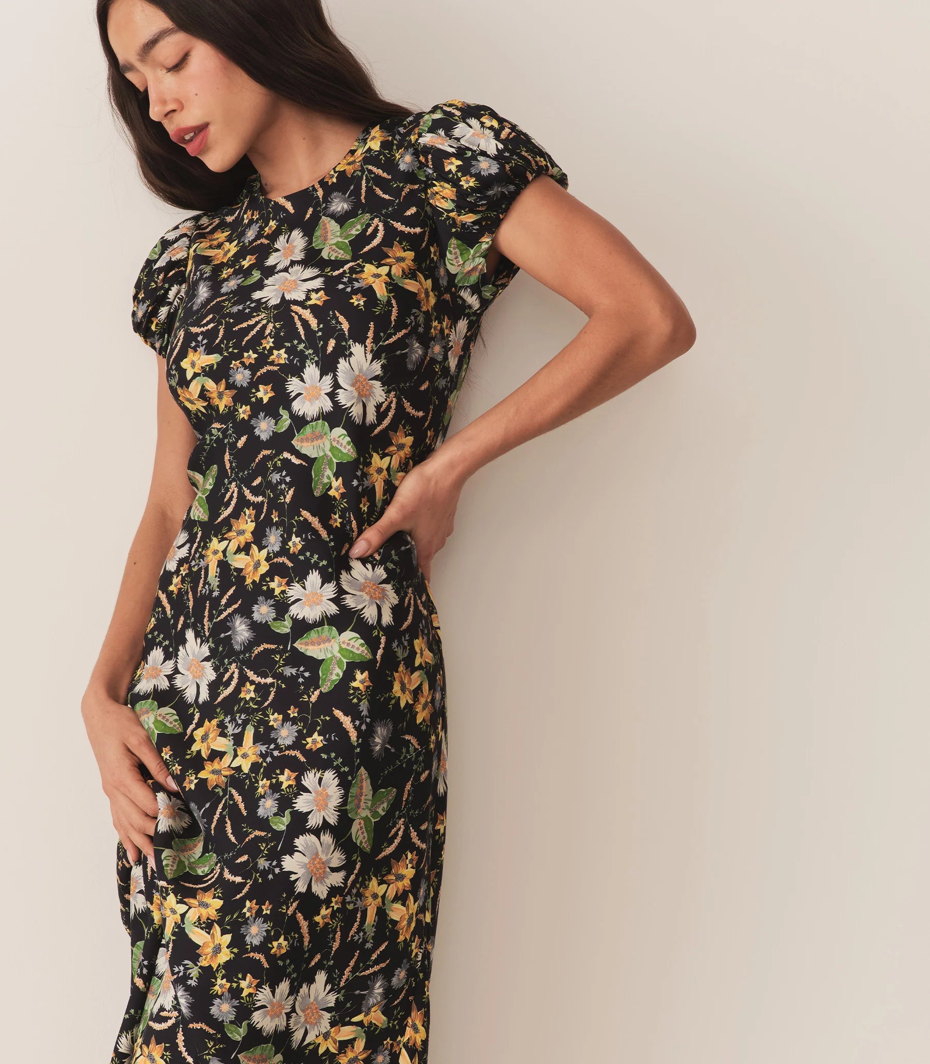 Crafted from a drapey silk-viscose twill, the Merla Dress by Doen in Sweet Anemone boasts an elegant bias cut that flatters the silhouette. Inspired by Art Deco motifs, this dress features a refined high neck and delicate short puffed sleeves, blending timeless style with modern sophistication. Perfect for occasions that call for understated glamour.