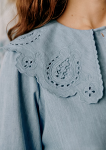 The Flavie Shirt combines timeless elegance with expert craftsmanship. Featuring a large embroidered collar that adds a refined, artisanal touch, this long-sleeve shirt boasts a classic button-down front for versatile styling. Its tailored design ensures a polished look suitable for both professional and casual settings, making it a sophisticated addition to any wardrobe.