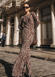 Indulge in the beauty of nature with the Zebra Maxi Dress! Featuring a beautiful floral print and transparent mesh detailing, this dress is perfect for any summer party. The round neckline and flowy design add a touch of elegance and fashion to your wardrobe. Elevate your style with this must-have dress!