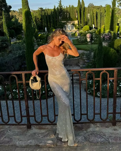 Elevate your style with the stunning Olympia Dress in ivory. This 90s-inspired slip dress features delicate sequin detailing that catches the light as you move. Hand-embellished by skilled artisans, this figure-skimming maxi dress boasts a chic column silhouette, delicate straps, and a cut-away back for high-voltage glamour.