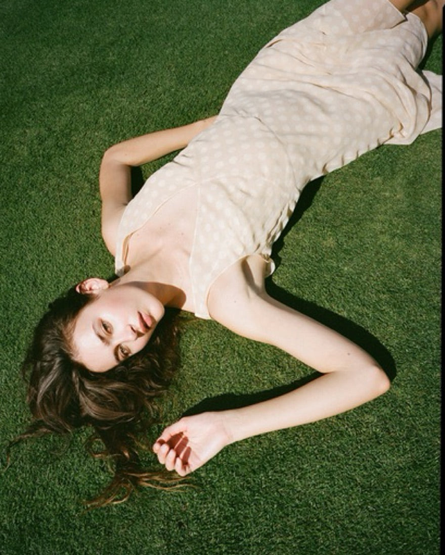 The Cleo Dress in Honey Spot by Realisation embodies effortless femininity with its light, floaty fabric and delicate sheer design. Featuring a flattering plunging V-neckline, sculpting panelled waist, and a fluted skirt that drapes gracefully, this dress is perfect for warm summer days and sultry evenings. The slightly shorter hemline adds a playful touch, while the removable underslip allows you to customize your look—opt for bold sheerness or a more refined silhouette. 