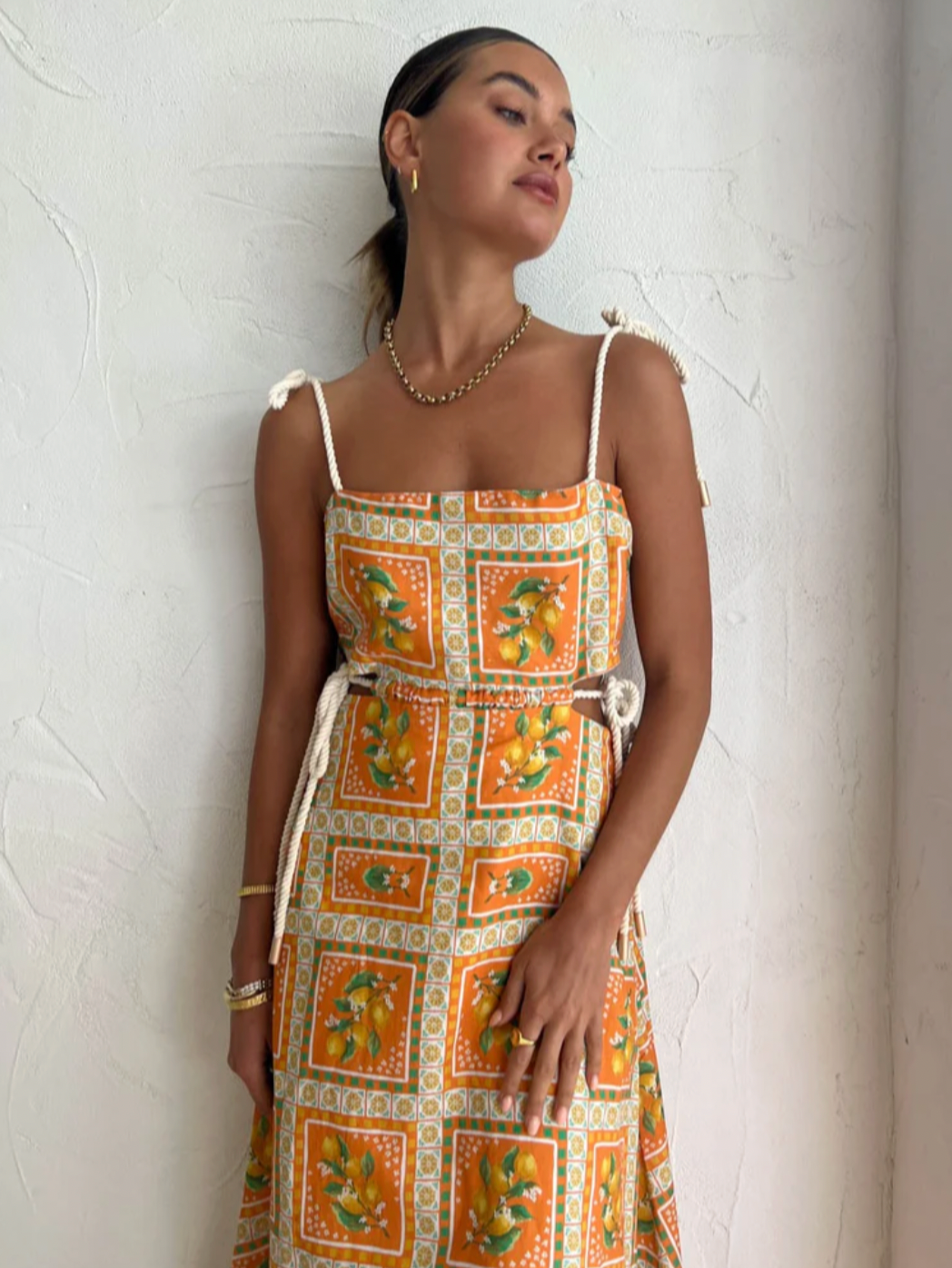 Embrace the essence of a Sicilian summer with the Lemonade Tie Maxi Dress in Orange Mosaic. Made from a breathable linen-cotton blend and fully lined, this dress offers comfort through long summer days. Its straight neckline and fitted bodice flatter the silhouette, while adjustable rope shoulder and waist ties provide a personalized fit. 