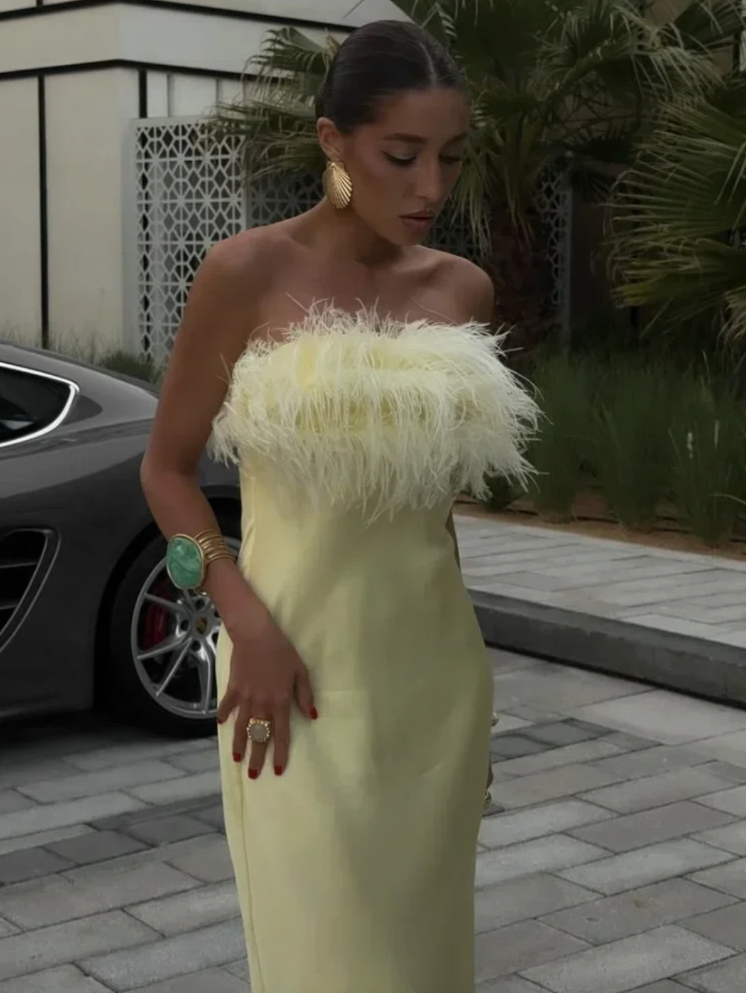 Crafted from smooth satin, this strapless dress features delicate feather detailing that adds an elegant, textured dimension. Its structured bodice provides a flattering fit while maintaining comfort and support. Ideal for formal occasions, the dress offers a refined silhouette that balances sophistication with subtle drama, making it a standout choice for evening events or special celebrations.