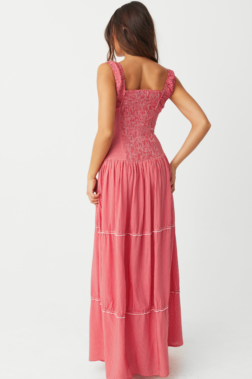 Unleash your inner free spirit in the Christabelle Ruffle Dress in Ladybug by Frankies Bikinis. The smocking details on the back provide a flattering fit, while the ruffle accents and fixed buttons add a touch of whimsy. Made from 100% rayon, this prairie maxi dress is perfect for any weekend adventure.