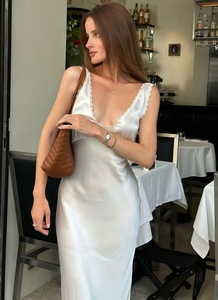 Elevate your evening look with the Allegra Satin Dress, a sleeveless, slim-fit gown designed to flatter your silhouette. Crafted from smooth satin, it features an elegant lace V-neckline and a high waist that enhances your figure. Perfect for sophisticated parties and special occasions, this dress combines timeless style with a touch of sensuality for a truly captivating presence.
