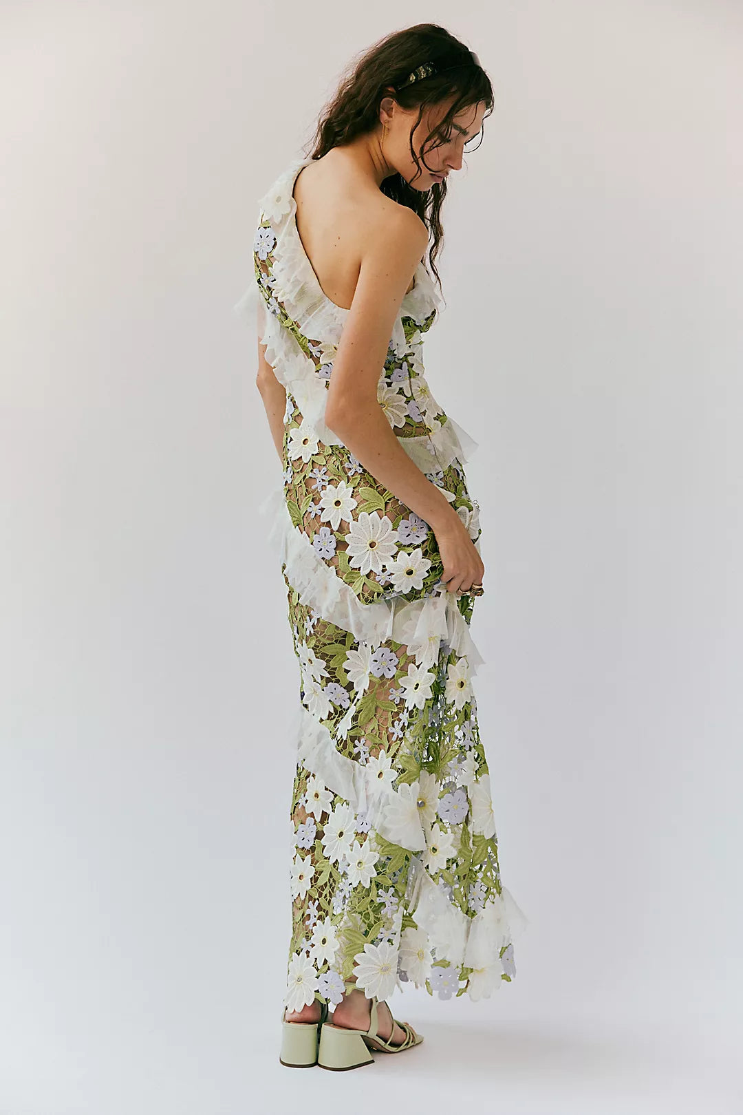 Experience effortless femininity and ethereal beauty in the Flora Maxi Dress. Crafted from delicate embroidered lace, this slim-fitting silhouette boasts an asymmetric neckline and cascading ruffles that add a touch of romance. The flared A-line hem and invisible zipper make for a flattering fit. Perfect for any special occasion!