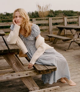 Crafted from 100% organic cotton poplin, the Quinn Dress in Dahlia Ditsy by DOEN offers refined comfort with a scoop neckline accented by an adjustable tie and an elegant keyhole detail, creating a graceful silhouette perfect for any occasion.
