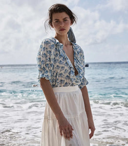 The Henri top in Bleu Rosier Floral offers a refined yet approachable style, crafted from soft fabric adorned with a delicate blue floral pattern. Its subtle ruffle detail and V-neckline enhance the rustic charm while the gently fitted silhouette flatters the figure. Pair it effortlessly with blue denim for versatile looks that transition seamlessly from casual daywear to polished evening ensembles with the right footwear choice.