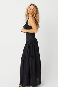 The Christabelle Dress in Black is the perfect addition to your spring wardrobe. Designed with smocking details and ruffle accents, this maxi dress exudes a feminine and playful look. With fixed buttons and a prairie silhouette, it's both stylish and comfortable. Slip into it and your favorite pair of pumps for the ultimate weekend outfit.