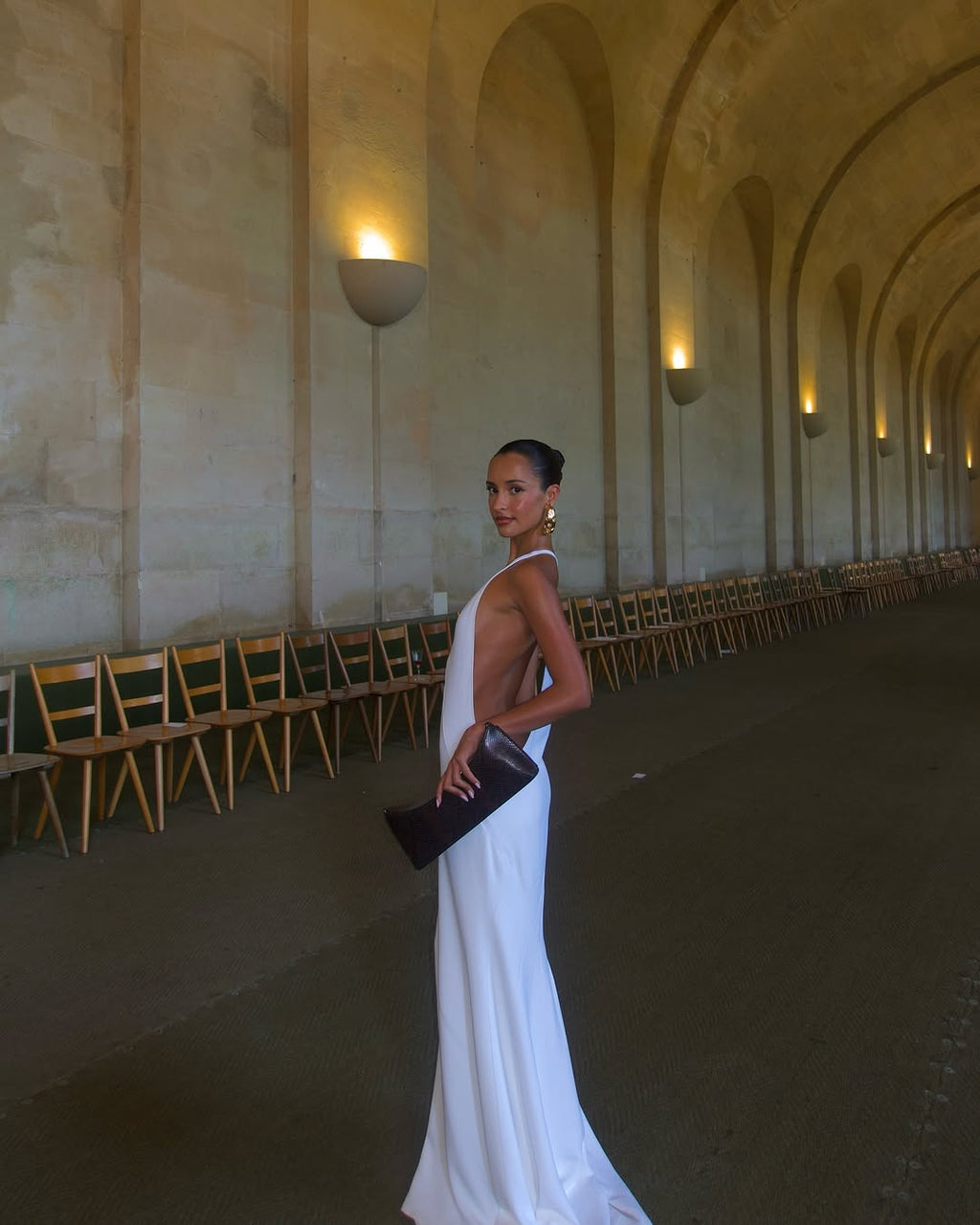 The Marcel dress by Jacquemus exudes elegance with its floor-length mermaid silhouette crafted from stretch crepe for a flattering fit. Featuring delicate chiffon lining and a racerback design, it showcases sophisticated triangle cutouts and bias-cut details at the front, creating a refined and captivating look for any special occasion.