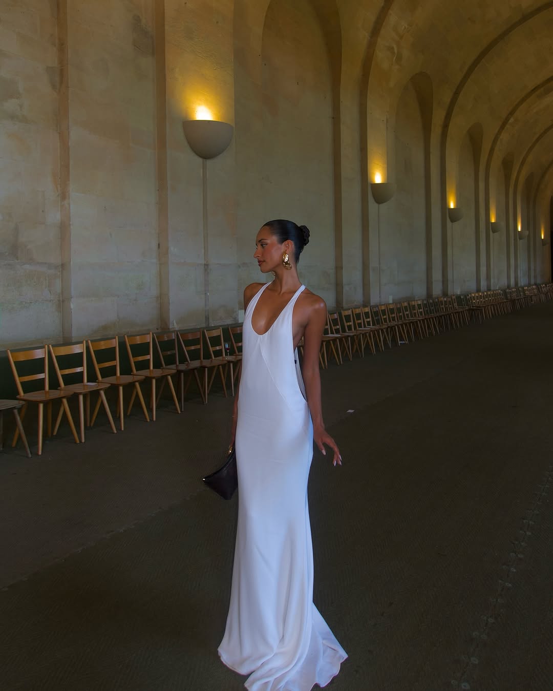 The Marcel dress by Jacquemus exudes elegance with its floor-length mermaid silhouette crafted from stretch crepe for a flattering fit. Featuring delicate chiffon lining and a racerback design, it showcases sophisticated triangle cutouts and bias-cut details at the front, creating a refined and captivating look for any special occasion.