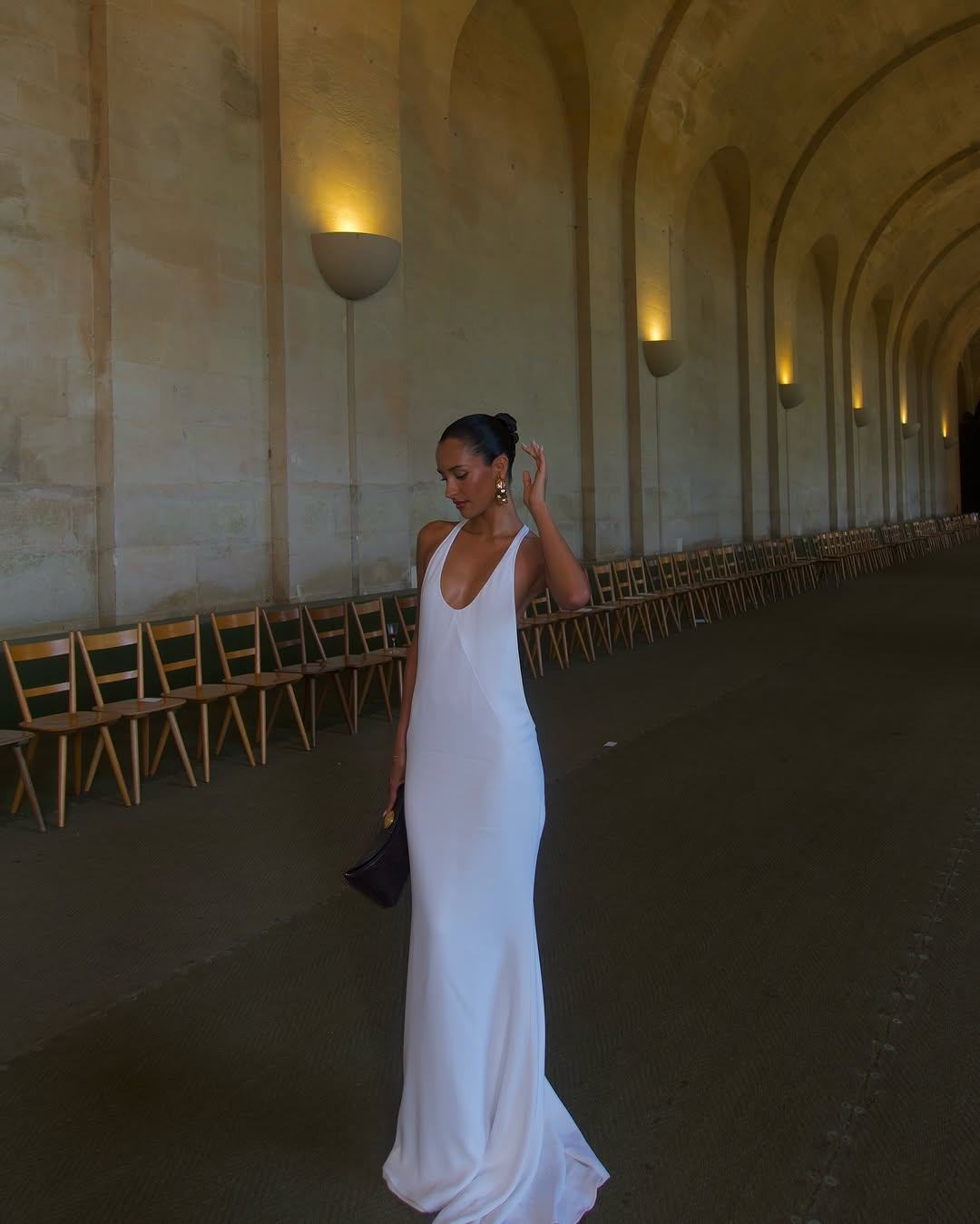 The Marcel dress by Jacquemus exudes elegance with its floor-length mermaid silhouette crafted from stretch crepe for a flattering fit. Featuring delicate chiffon lining and a racerback design, it showcases sophisticated triangle cutouts and bias-cut details at the front, creating a refined and captivating look for any special occasion.