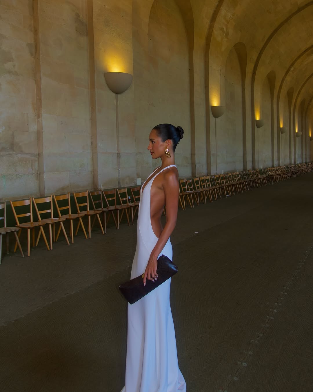 The Marcel dress by Jacquemus exudes elegance with its floor-length mermaid silhouette crafted from stretch crepe for a flattering fit. Featuring delicate chiffon lining and a racerback design, it showcases sophisticated triangle cutouts and bias-cut details at the front, creating a refined and captivating look for any special occasion.