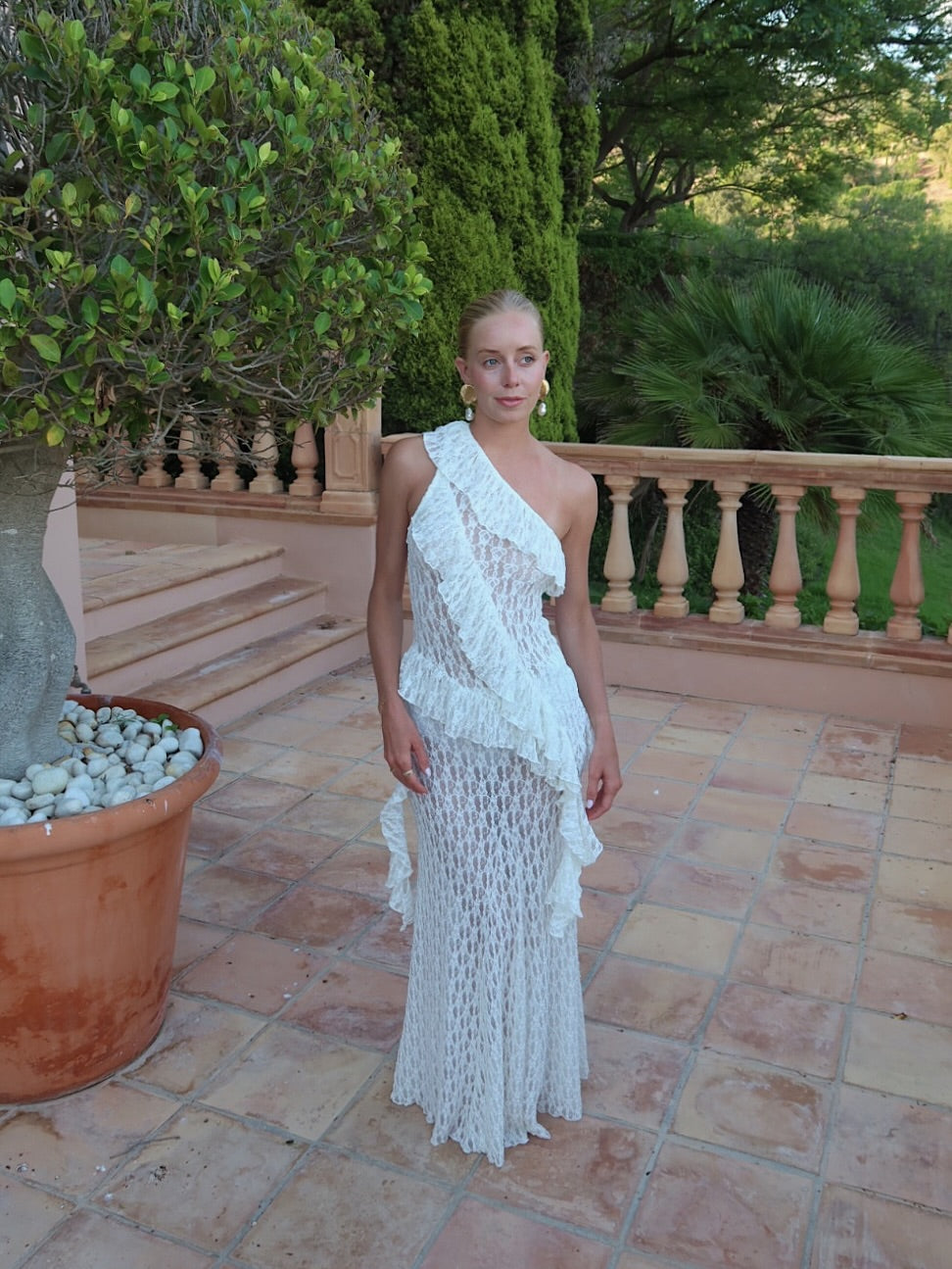 Elevate your wardrobe with the Asymmetric Lace Set, designed for those who appreciate refined elegance. The high-waisted semi-sheer long skirt ensures a comfortable fit thanks to its elastic waistband, while the semi-sheer top features an asymmetric neckline and delicate ruffle accents that add a sophisticated edge. This ensemble seamlessly blends subtle allure with comfort, making it an ideal choice for sophisticated occasions where impeccable style is paramount.